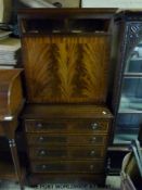 A reproduction cabinet with fall flap to top and four drawers to base (H137 x W64 x D44cm)