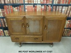 Ercol light elm retro sideboard with three doors and one drawer (H82 x W116 x D45cm)