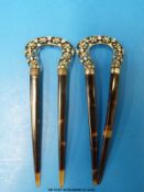 A pair of white metal and faux tortoiseshell hair clips set with paste in floral design