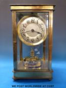 A brass and bevelled glass cased Anniversary clock with silvered dial and a fused bi-metal split