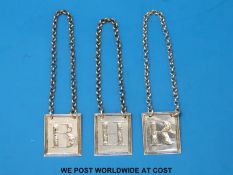 A set of three Georgian hallmarked silver rectangular bottle labels B, R and H (brandy,