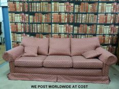 A red upholstered three seat sofa (Length 245cm)