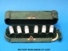 A cased set of six miniature white metal peppers marked sterling,