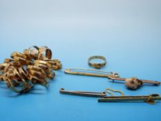 Twenty four silver buckle rings with a gilt finish, rolled gold brooch, 9ct gold brooch,