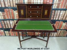 An inlaid mahogany Bonheur de Jour with three drawers and two cupboards to top fold over writing