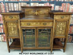 A late 19thC inlaid rosewood sideboard having central drawer with bevelled glazed doors below,