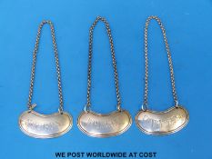 A set of three Victorian Goldsmiths and Silversmiths Co hallmarked silver bottle labels comprising