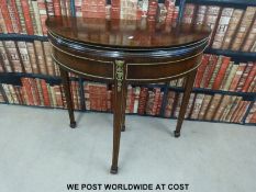 A cross bonded and ormolu mounted style walnut fold over card table (H86, W90,