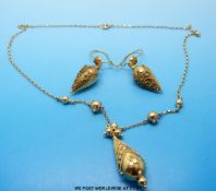 A yellow metal necklace and matching earrings marked 15k,