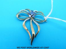 A 9ct gold bow brooch set with topaz to the centre and diamond decoration