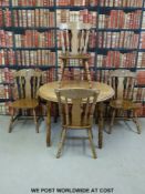 A circular beech kitchen table and four chairs (height 77cm diameter 190cm)