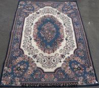A large floral design rug on blue ground 344x242 cm