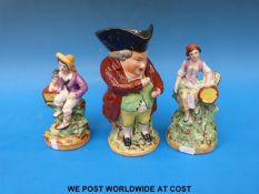 Three Staffordshire figures including two musicians and a Toby taking snuff