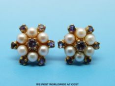 A pair of 9ct gold earrings set with pearls and amethyst in a cluster