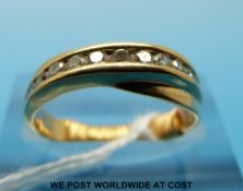A gold ring set with diamonds in a cross over setting (size J)