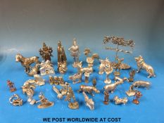 A collectors' cabinet full of novelty animals and figures including a cockerel, Indian goddess,