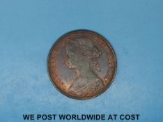 An 1860 Victoria bun head penny, Lew below shield, toothed borders,