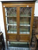 A late 19th / early 20thC mahogany and satinwood display cabinet with astragal glazed doors,