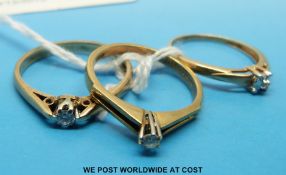 Two 9ct gold rings set with a diamond solitaire and a 10k gold ring set with a diamond solitaire
