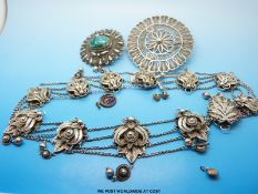 A white metal necklace in a filigree design,