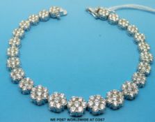 An 18ct white gold bracelet set with 25 flower clusters,