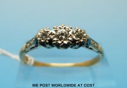 An 18ct gold three-stone diamond ring (size T/U)