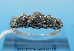 An 18ct gold ring set with five old cut diamonds in a platinum setting,