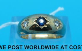 A 9ct gold ring set with a sapphire and two diamonds in star settings (Size K)