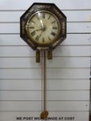 A Georgian octagonal shaped wall clock with two-train movement set in wooden frames and face with