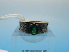 A 14ct gold ring set with an emerald and diamonds (size S)