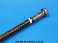 A white metal-topped zebra wood walking cane