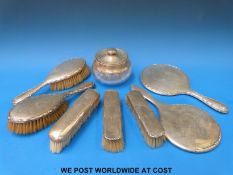 A hallmarked silver dressing table set comprising hand mirror and four brushes together with a