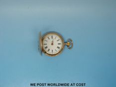 A ladies late 19thC fob watch in hunter case stamped 14Kt decorated with foliate design inlaid with