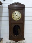 A c1910 two-train striking wall clock in oak case