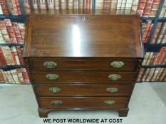 A Georgian mahogany bureau with four long graduated drawers and fitted interior,