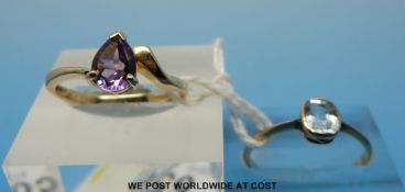 A 9ct gold ring set with a pear cut amethyst and a yellow metal ring set with an aquamarine (size