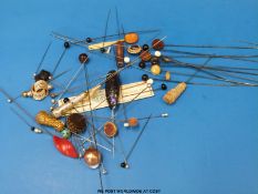 A collection of hat pins with tops including agate, beaded, turquoise,
