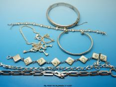 A silver bangle and six silver bracelets