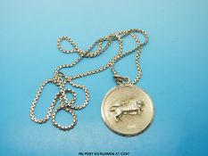 A silver chain and Taurus medallion both marked 925