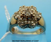 A 14ct gold ring set with diamonds in a flower cluster (size S)