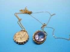 An Edwardian pendant set with an oval cut amethyst on 9ct gold chain and a 9ct gold locket