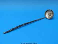 A coin inset toddy ladle with whalebone handle,