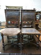 A set of six continental oak and tooled leather dining chairs with carved and pierced decoration