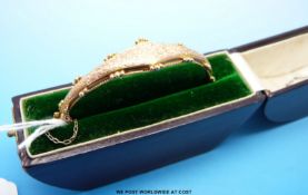 An Edwardian hallmarked 9ct gold bangle with chased floral decoration in original box for Walter