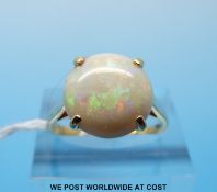 An 18ct gold ring set with a round opal cabochon (size O)