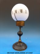 A French candlestick globe clock with bronze knopped stem surmounted by a glass globe with Roman