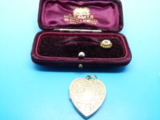 A 9ct gold stick pin set with a ruby in original box and a gold heart shaped locket
