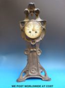 A French Art Nouveau cast metal clock with maker's name stamped to the movement,