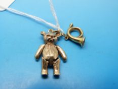 A 9ct gold teddy bear charm and a 9ct gold trumpet charm (14g)