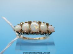 A 9ct gold ring set with five oval opals (size S)